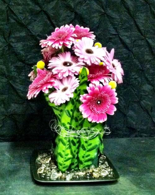 Pink gerbers, billie balls and striking leaves as the vase